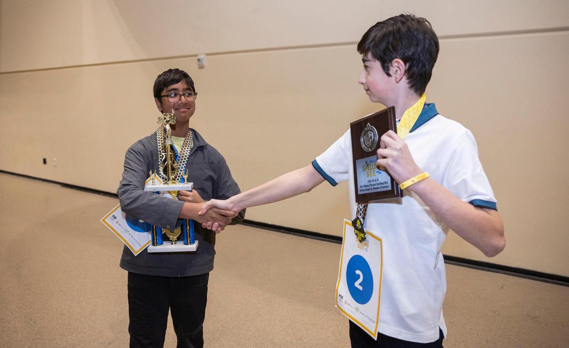 Nikhil Sha, left, the 85th Miami Herald Spelling Bee for Miami-Dade and Monroe County winner, shakes hands with David Furman, a seventh grader from Aventura City of Excellence Charter School, who placed second in the competition.