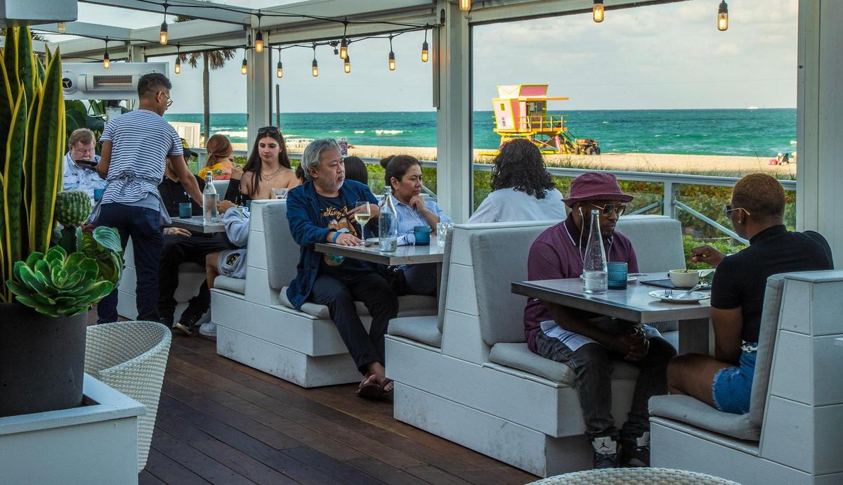 Guests dine in the outdoors dining room at Ocean Social by Tristen Epps on Miami Beach.