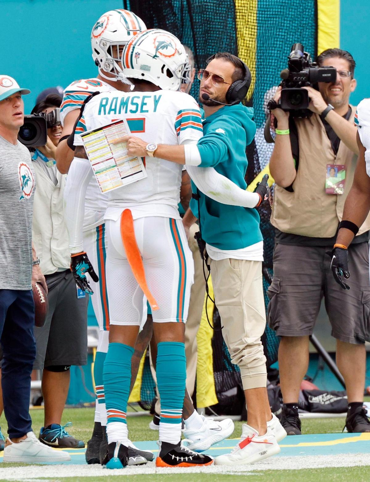 Miami Dolphins coach Mike McDaniel congratulates Jalen Ramsey (5) interception in the second quarter against the New England Patriots at Hard Rock Stadium in Miami Gardens on Sunday, October 29, 2023.