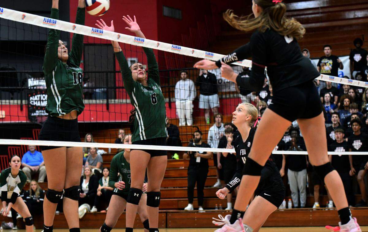 Miami Westminster Christian junior outside hitter Lia Gonzales and sophomore Alyana Cadavid block a shot during a Class 2A state semifinal match against Naples First Baptist on Tuesday at Polk State College.