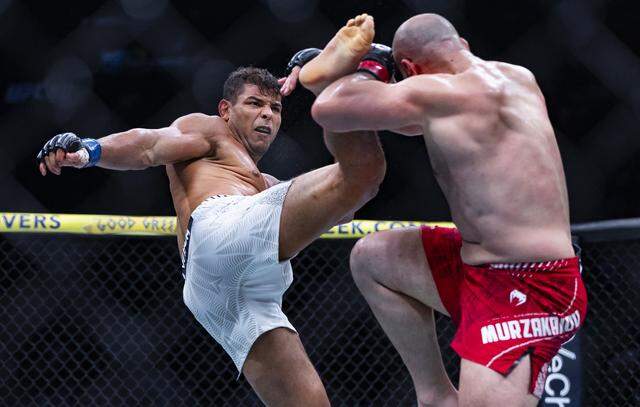 Azamat Murzakanov of Russia and Paulo Costa of Brazil fight in their light heavyweight bout at UFC 327 at the Kaseya Center on Saturday, April 11, 2026, in downtown Miami, Fla.