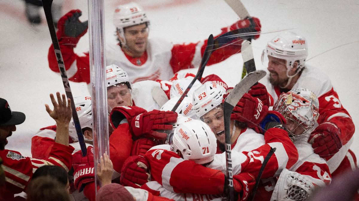 Detroit Red Wings defenseman Moritz Seider (53) hugs Detroit Red Wings center Dylan Larkin (71) after Larkin’s overtime goal during a hockey game against the Florida Panthers on Wednesday, Jan. 17, 2024, at Amerant Bank Arena in Sunrise, Fla. The Red Wings won 3-2 in overtime.