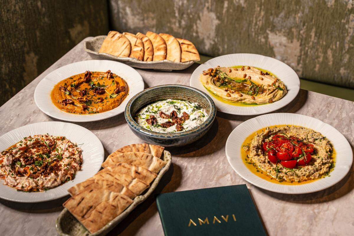 Shareable dips and pita bread at Amavi restaurant in Miami.
