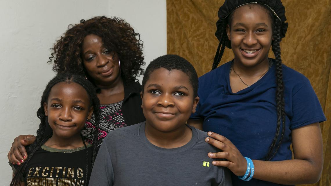 From left: Zoe Nyon, 8, Hetty Nyon, 45, Timothy Nijon, 14, and Hazel Nijon, 15, are photographed at their apartment in Liberty City, Florida, on Wednesday, Nov. 27, 2019. Timothy has a rare condition that caused him to lose his vision at age 5.