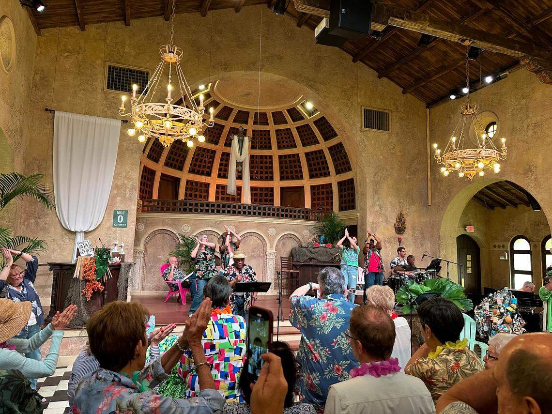 Congregants at Coral Gables Congregational Church do the Jimmy Buffett “Fins to the right/Fins to the left” gestures on stage and in the pews during Rev. Laurie Hafner’s “Gospel According to Jimmy Buffett” sermon on April 7, 2024.
