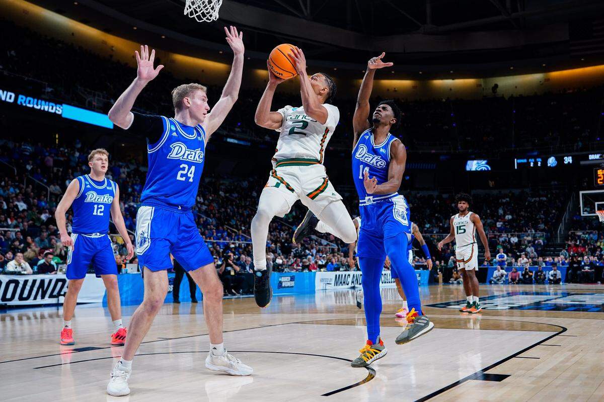 Miami Hurricanes guard Isaiah Wong (2) drives against Drake Bulldogs forward Nate Ferguson (24) and guard Sardaar Calhoun (14) in the second half at MVP Arena on Friday in Albany, N.Y. 