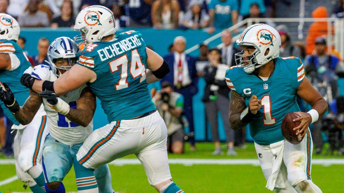 Miami Dolphins offensive tackle Liam Eichenberg (74) blocks Dallas Cowboys linebacker Micah Parsons (11) as Dolphins quarterback Tua Tagovailoa (1) sets up to pass during first quarter of an NFL football game at Hard Rock Stadium on Sunday, Dec. 24, 2023 in Miami Gardens, Fl.