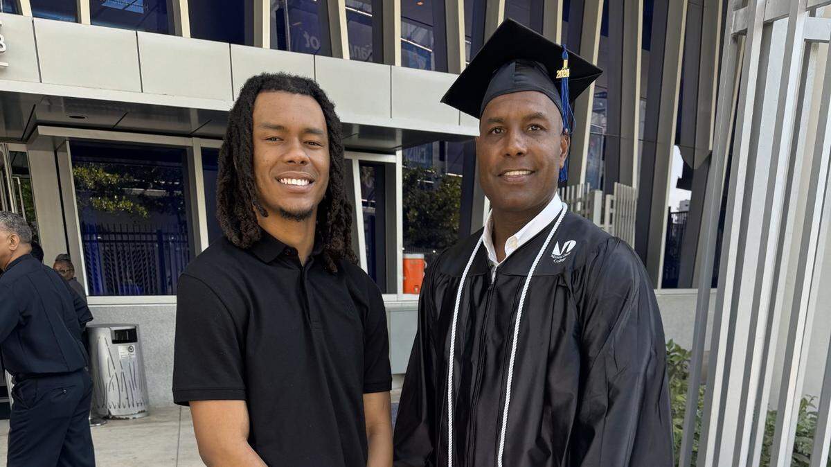 Darryl Richardson, right, poses with his son, Darryl Richardson Jr., after receiving his diploma on Saturday from Miami Dade College, where the father earned an associate’s degree from its Culinary Institute.
