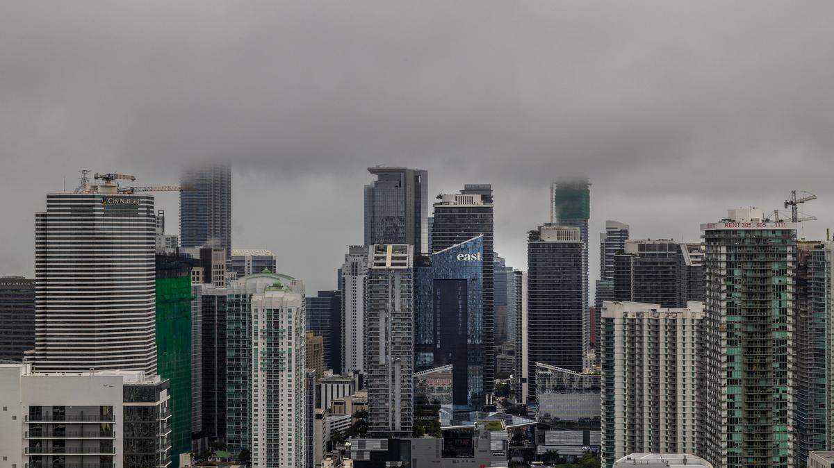 Low clouds cover the top of Miami’s skyline during a cloudy morning as the National Weather Service predicts rain chances near 50%, during the afternoon, on Wednesday, March 18, 2026.
