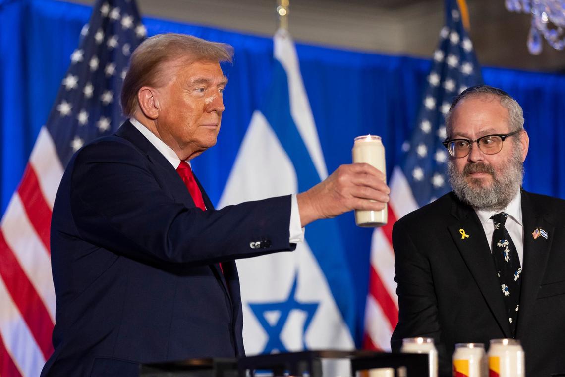 Republican presidential candidate and former President Donald Trump and Rabbi Yehuda Kaploun light a candle during a remembrance event at Trump National Doral Miami on Monday, Oct. 7, 2024, in Doral, Fla. The event honored the victims who lost their lives or were kidnapped in the Oct. 7 attacks in Israel by Hamas last year.