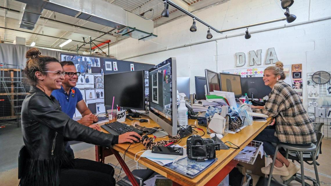 Graphic designer Joana Calafate works with creative director Shawn Boyer at left in the design room for the fashion brand Anatomie in Miami on Dec. 1.
