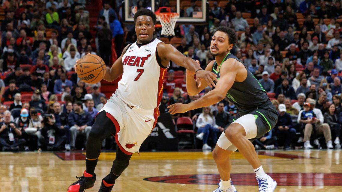 Miami Heat guard Kyle Lowry (7) drives against Minnesota Timberwolves guard Bryn Forbes (10) during the first quarter of an NBA game at FTX Arena in Miami, Florida, on Monday, December 26, 2022.