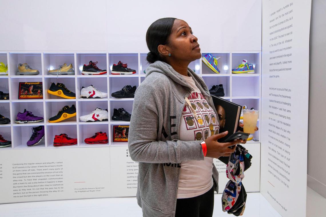 Miami Heat fan Samantha Ketant, appreciates artwork in honor of 305 legend Dwyane Wade before a moderated discussion with Wade for his new memoir “Dwyane.” at The Shop Miami in the Wynwood neighborhood of Miami, Florida, on Friday, November 19, 2021.