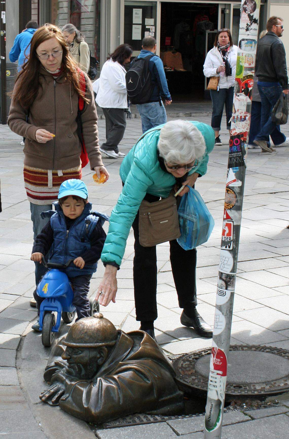 In Bratislava’s old quarter, tourists touch the hat of a worker emerging from a manhole, one of the area's whimsical statues. Touching the bronze, titled  “Čumil,” is reputed to bring good luck.