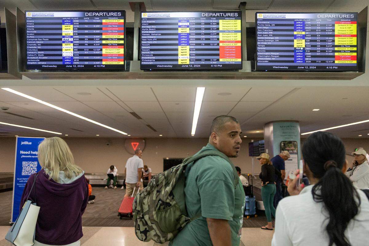 James Rodriguez talks with his wife, Diana, after their flight to Cancun was canceled at the Fort Lauderdale-Hollywood International Airport due to heavy downpours across South Florida on Wednesday, June 12, 2024 in Fort Lauderdale, Fla.