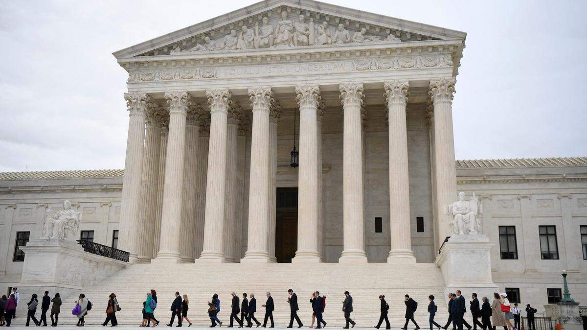 Protestors and supporters gather in front of the U.S. Supreme Court in 2019 in Washington as the justices hear three challenges from New York, Michigan and Georgia involving workers who claim they were fired because they were gay or transgender.