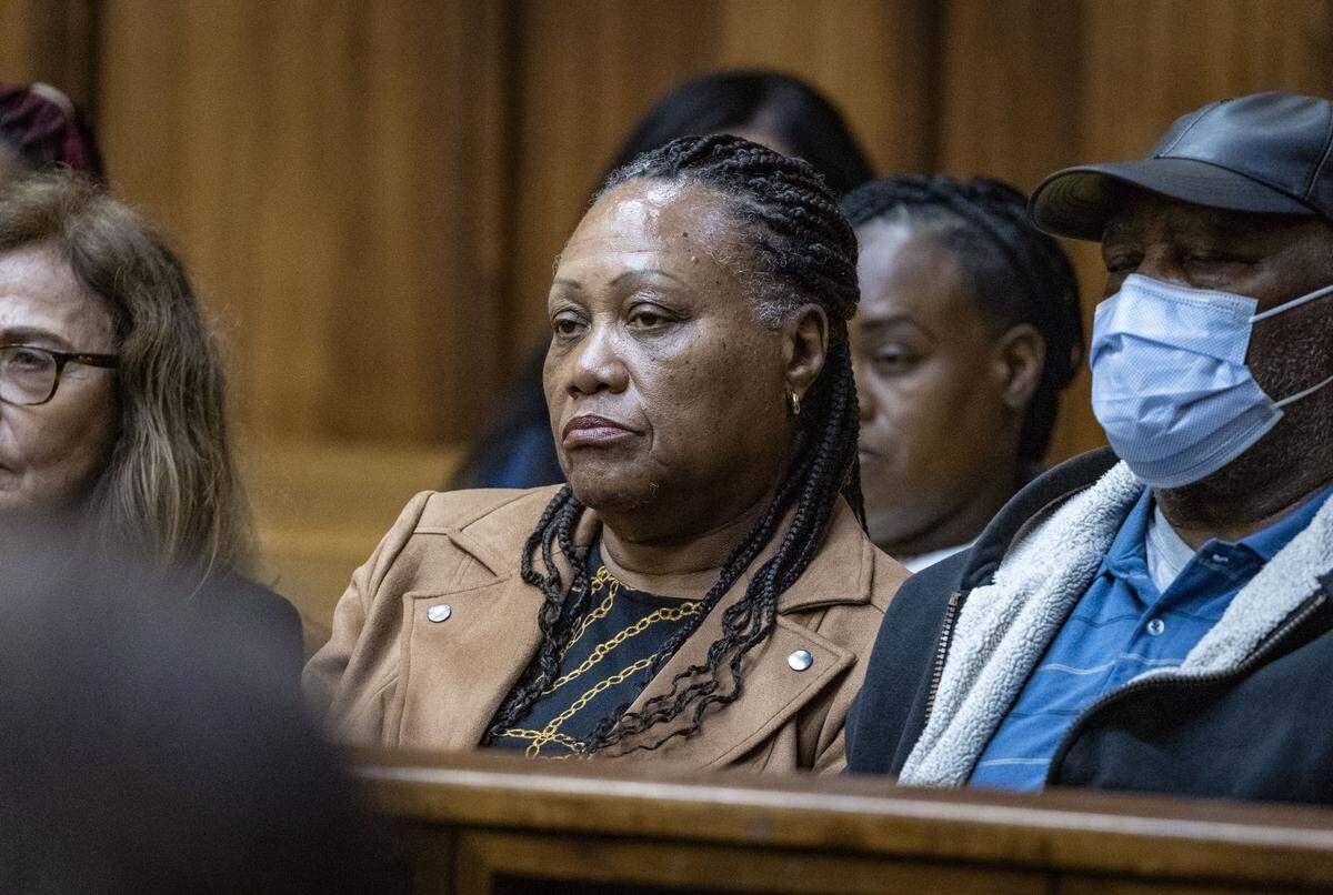Miami, FL, November 5, 2025 - Charlie Postell, center, the mother of Marlin Barnes, listens to closing arguments during the retrial of Labrant Dennis who was convicted in 1998 of killing Timwanika Lumpkins, his ex-girlfriend, and UM linebacker Marlin Barnes. Jurors will now decide if he should go back to death row.