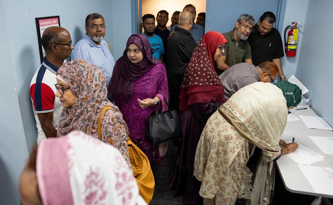 People arrive to a public zoning meeting at the South Dade Regional Library. The meeting, which was postponed, was set to discuss the rezoning request for a new Muslim cemetery in Southwest Dade. Some residents are opposing the project, while the Muslim community feels its necessary due to the growing population and strict religious burial tenants.