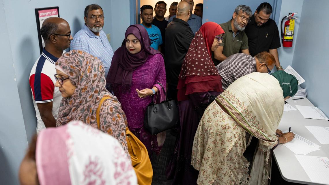 People arrive to a public zoning hearing at the South Dade Regional Library on Tuesday, Nov. 12, 2024. The meeting, which was postponed due to a lack of quorum, was set to discuss a proposed Muslim cemetery site in the Redlands.