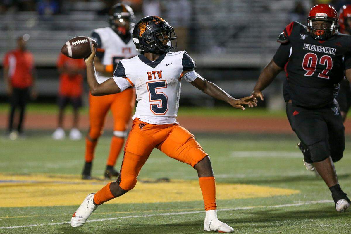 Booker T. Washington quarterback Claudell Sherman (5) throws the football during the second quarter of a high school football game against Miami Edison at Curtis Park in Miami, Florida, on Thursday, September 1, 2022.