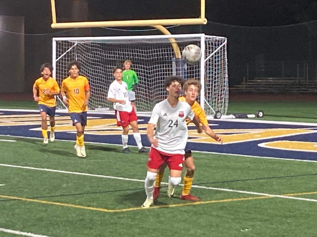 Miami Beach’s Evan Rice chases down a loose ball during Friday night’s Region 4-6A boys’ soccer semifinal at St. Thomas Aquinas High School.
