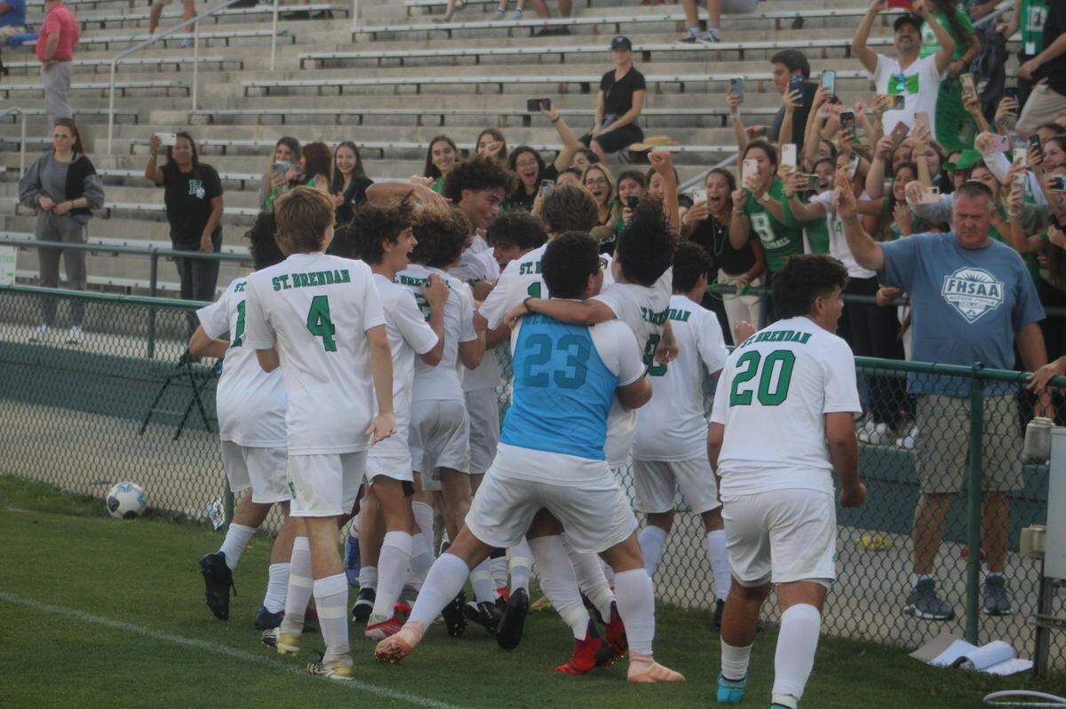 St. Brendan boys soccer players celebrate with their fans just seconds after they beat Orlando Bishop Moore 1-0 in the Class 4A final to secure the school’s first-ever state championship in the sport.