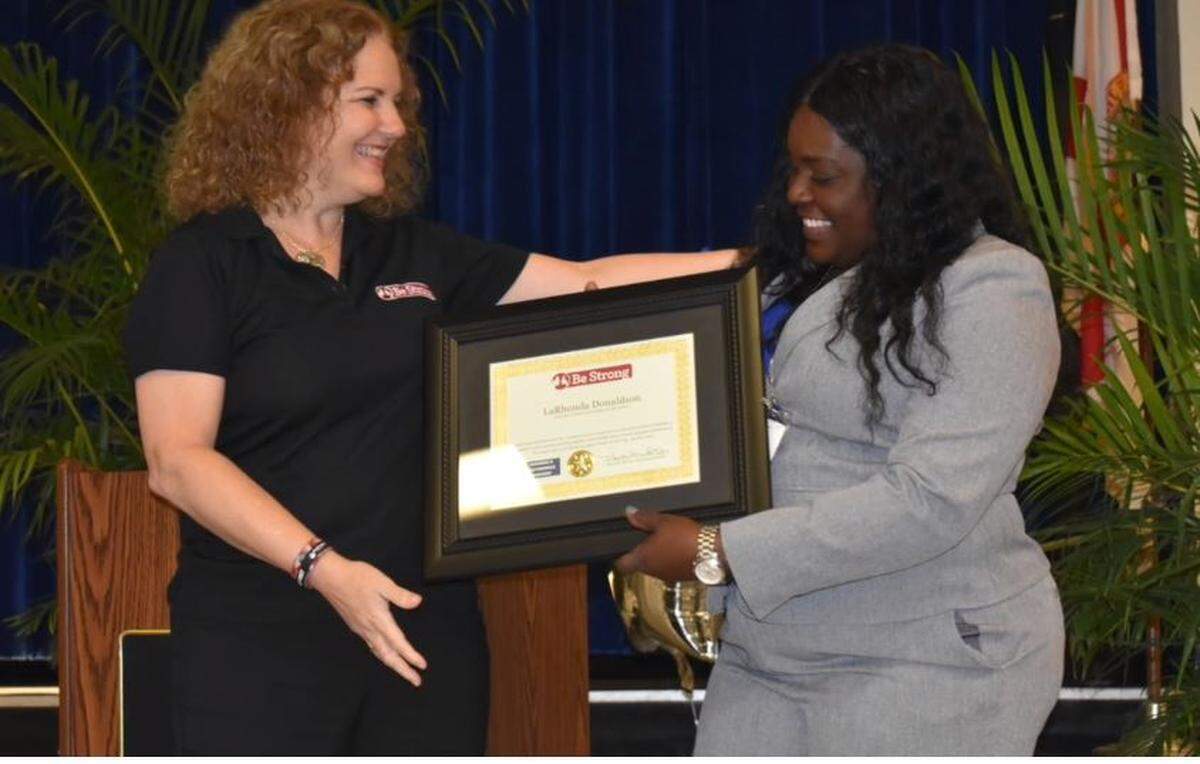 Youth Enrichment Director Celida Hernandez with Richmond Heights Middle School Principal Larhonda M. Donaldson at the yearbook ceremony, the first in seven years.