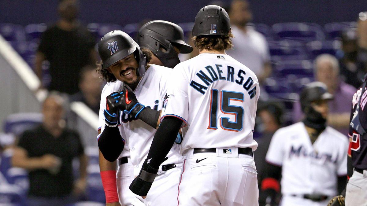 Miami Marlins catcher Jorge Alfaro (38) is congratulated by Marlins third baseman Brian Anderson (15) after hitting a three runs home run during the first inning of their baseball game against the Washington Nationals at loanDepot park on Thursday, August 26, 2021 in Miami, Florida.