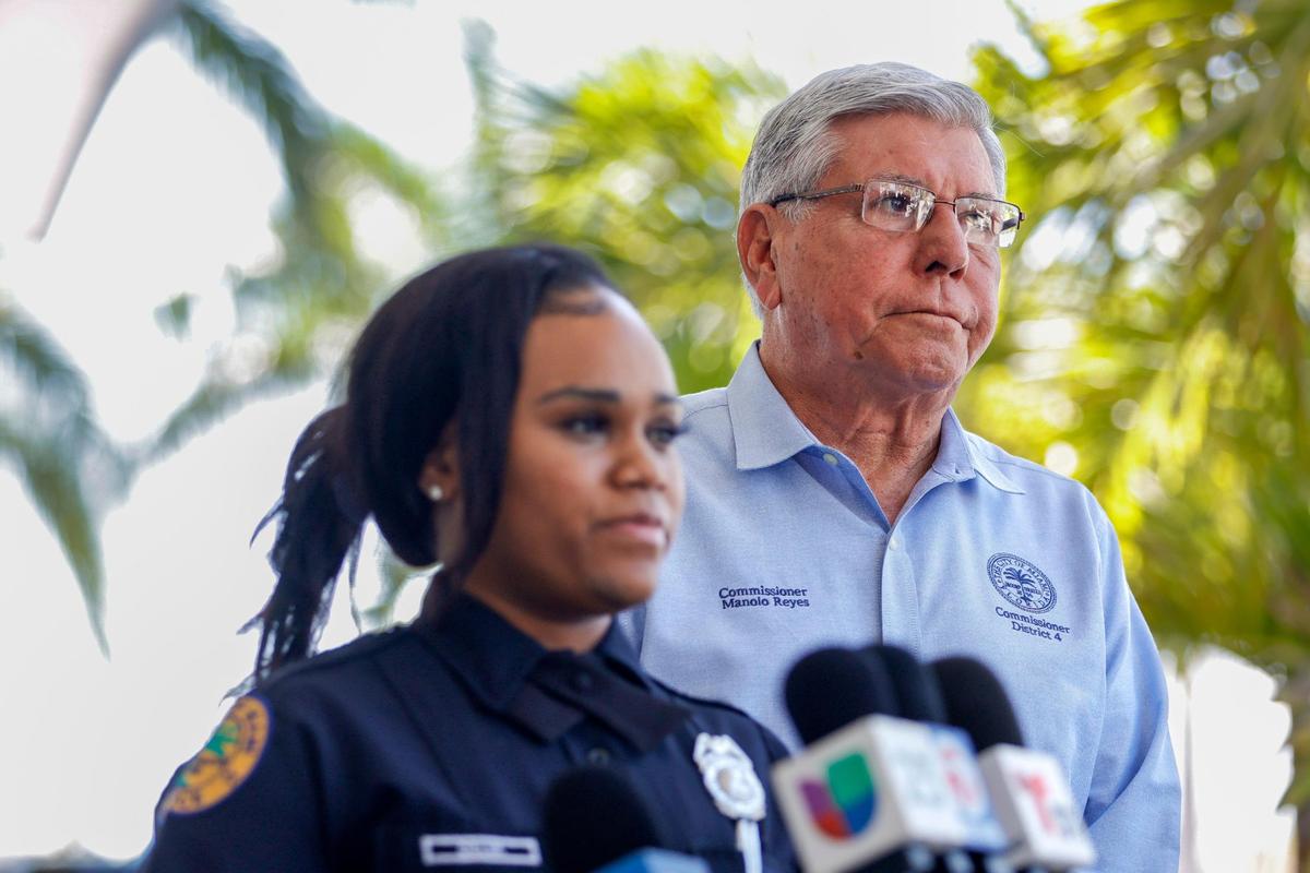 City of Miami Public Information Officer Kiera Delva, joined by Miami Commissioner Manolo Reyes, talks to reporters outside City Hall as City of Miami police officers investigate a possible break-in at the commissioner’s office in Coconut Grove, Florida, on Monday, Feb. 27, 2023.