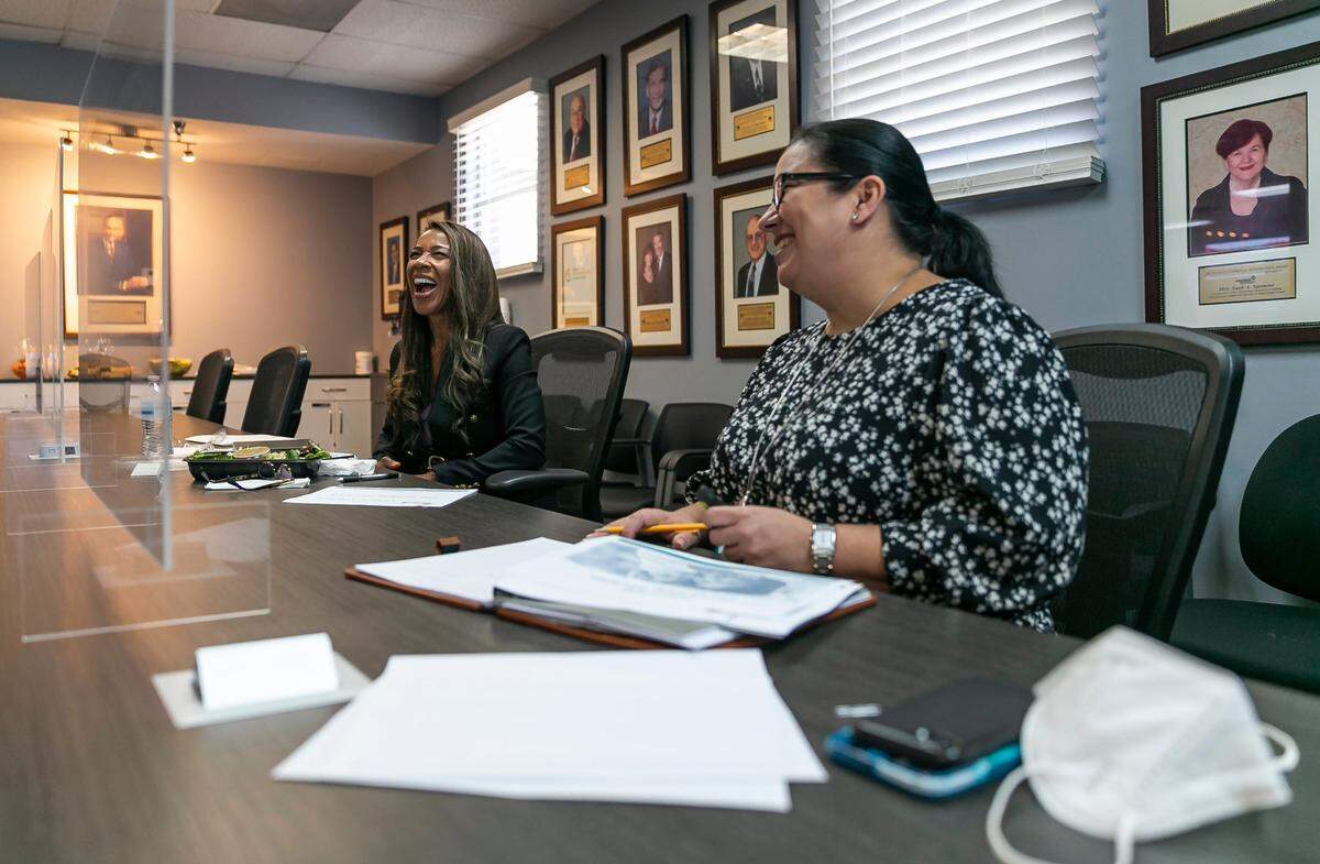 Symeria Hudson, the president and CEO of Chapman Partnership, left, has a meeting with Xiomara Alonso, Chapman’s vice president of human resources, at Chapman’s Miami offices.