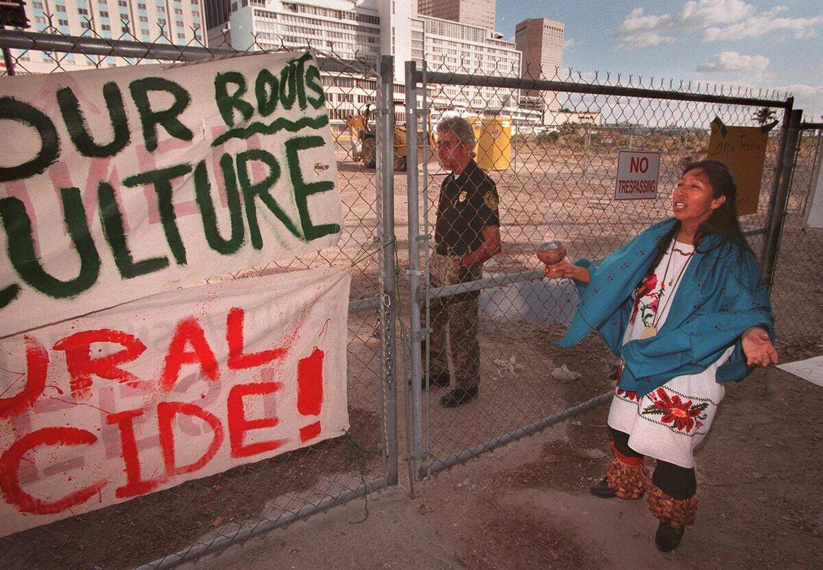 Geeta Constantino, of Mayan and Huichol descent from Mexico, performs a dance at the gate blocking access to the site of the Miami Circle in 1999 during demonstrations to stop a condo development at the 2,000-year-old archaeological feature.