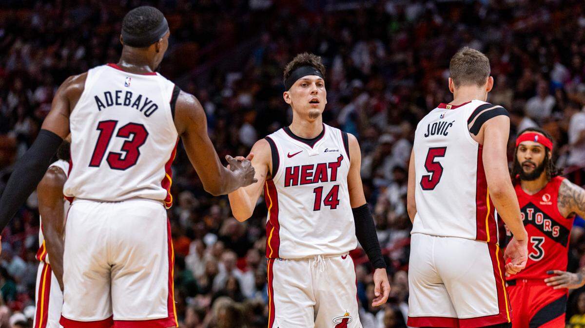 Miami Heat guard Tyler Herro (14) reacts with teammate Bam Adebayo (13) during the second half of an NBA game against the Raptors at Kaseya Center in Miami, Florida, on Friday, April 12, 2024.