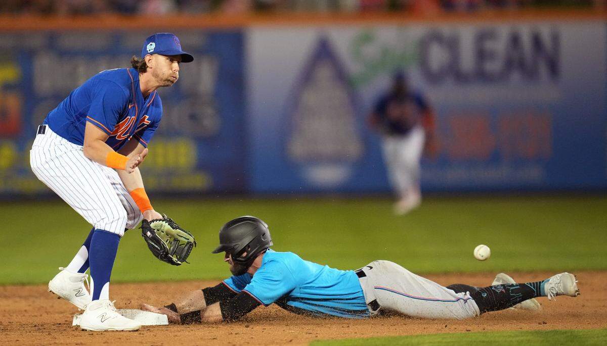Feb 25, 2023; Port St. Lucie, Florida, USA; Miami Marlins second baseman Jon Berti (5) steals second base as New York Mets second baseman Jeff McNeil (1) covers on the play in the third inning at Clover Park. Mandatory Credit: Jim Rassol-USA TODAY Sports
