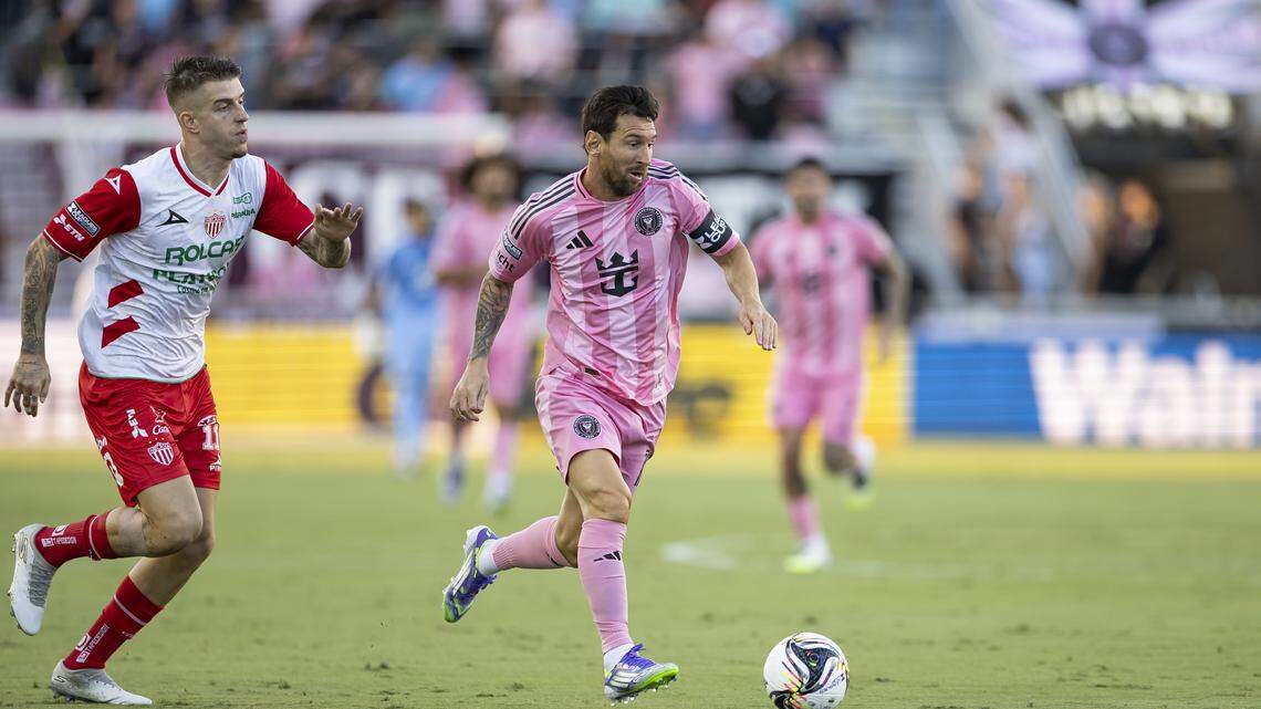 Inter Miami CF forward Lionel Messi (10) runs with the ball as Necaxa midfielder Raul Sanchez (11) defends in the first half of their Leagues Cup Phase One soccer match at Chase Stadium on Saturday, Aug. 2, 2025, in Fort Lauderdale, Fla.