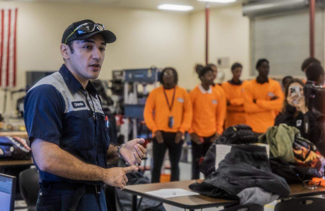 Orlando Gonzalez, an automotive teacher at Miami Carol City Senior High School talks the automotive school's program during an event to announce a donation by Florida Power and Light of an Electrathon electric vehicle (EV)-build kit to students in the Electric Vehicle Automotive Technology Magnet Program, as part of FLP's Electrathon program, during an event at the school's laboratories, on Thursday, January 22, 2026.