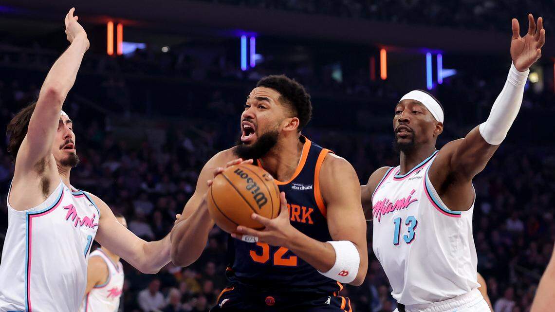 New York Knicks center Karl-Anthony Towns (32) drives to the basket against Miami Heat guard Jaime Jaquez Jr. (11) and center Bam Adebayo (13) during the first quarter at Madison Square Garden.