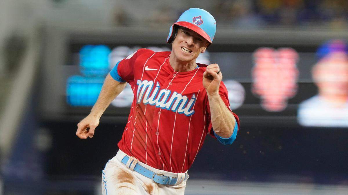 Miami Marlins’ Joey Wendle rounds third base on his way to score on a double by Garrett Cooper during the first inning of a baseball game against the New York Mets, Saturday, Sept. 10, 2022, in Miami. (AP Photo/Marta Lavandier)