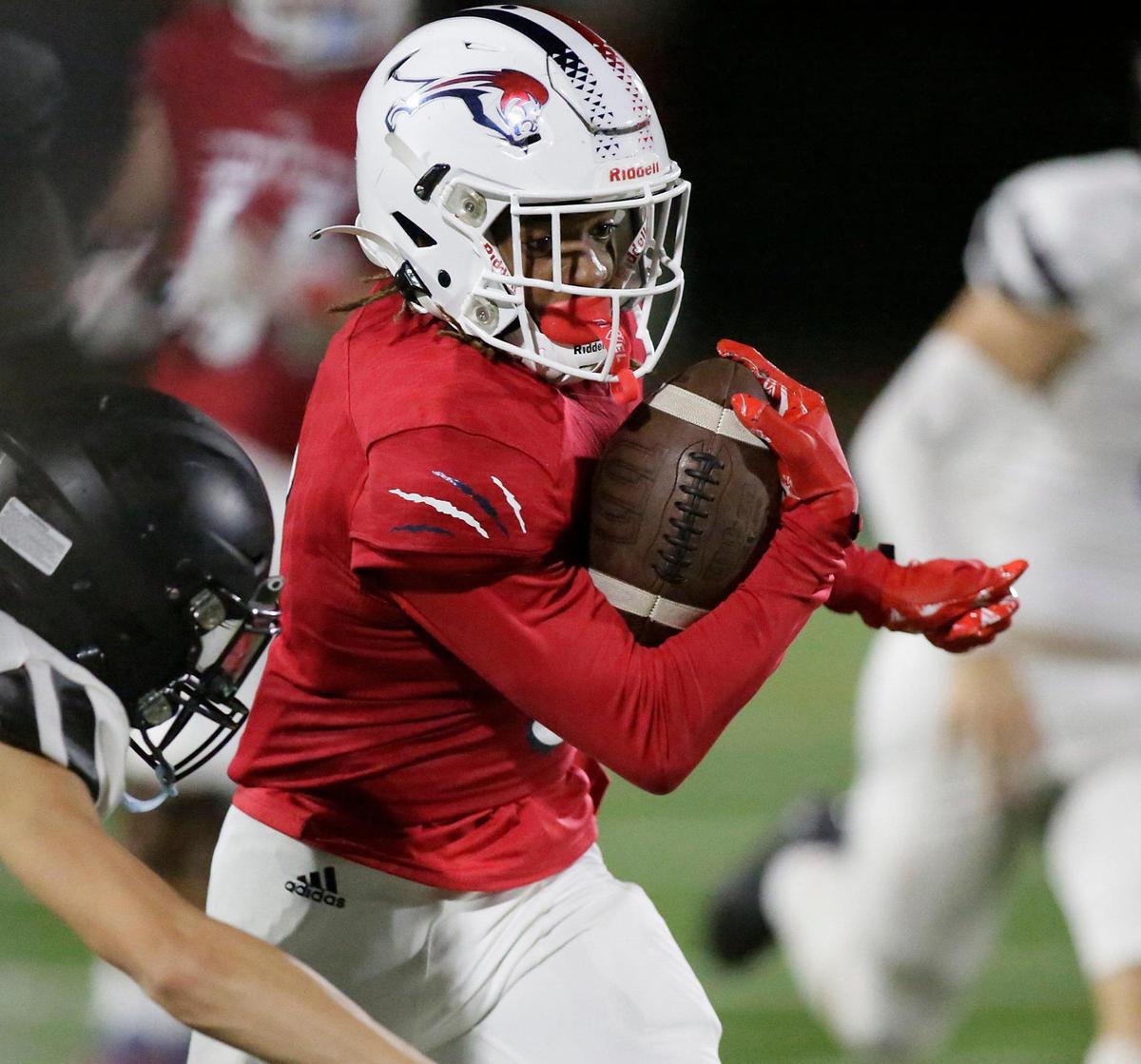 Chaminade-Madonna Lions wide receiver Kyle Washington (3) carries the ball agains Archbishop Carroll Bulldogs during the state semifinal football game on Friday, December 1, 2023 at Chaminade-Madonna School in Hollywood. Andrew Uloza / for Miami Herald
