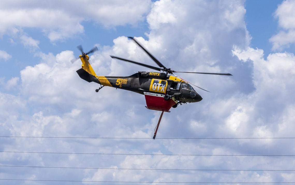 A water-tanker helicopter heads out to the south side of Tamiami Trail (U.S. 41) in the Everglades on Tuesday, April 28, 2026, to drop its load on flames burning thousands of acres of brush.