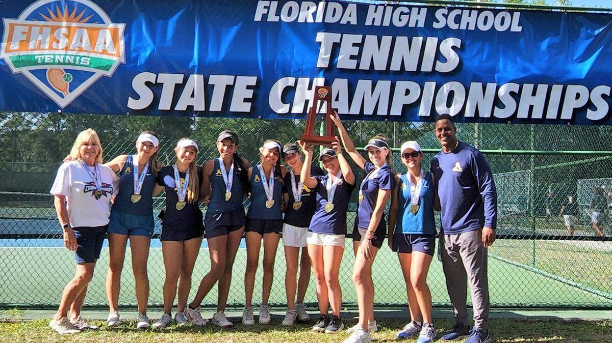 The St. Thomas Aquinas girls’ tennis team celebrates winning the Class 3A state championship for the program’s 12th overall state title.