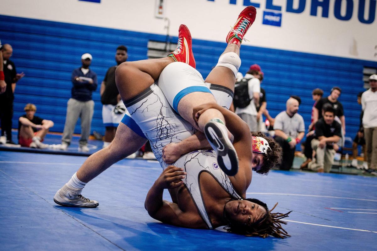 South Dade’s Sawyer Bartelt picks up Nathan Adras of Dr. Krop during the 2024 Boys GMAC wrestling 175-pound weight class championship final at South Dade High in Homestead.