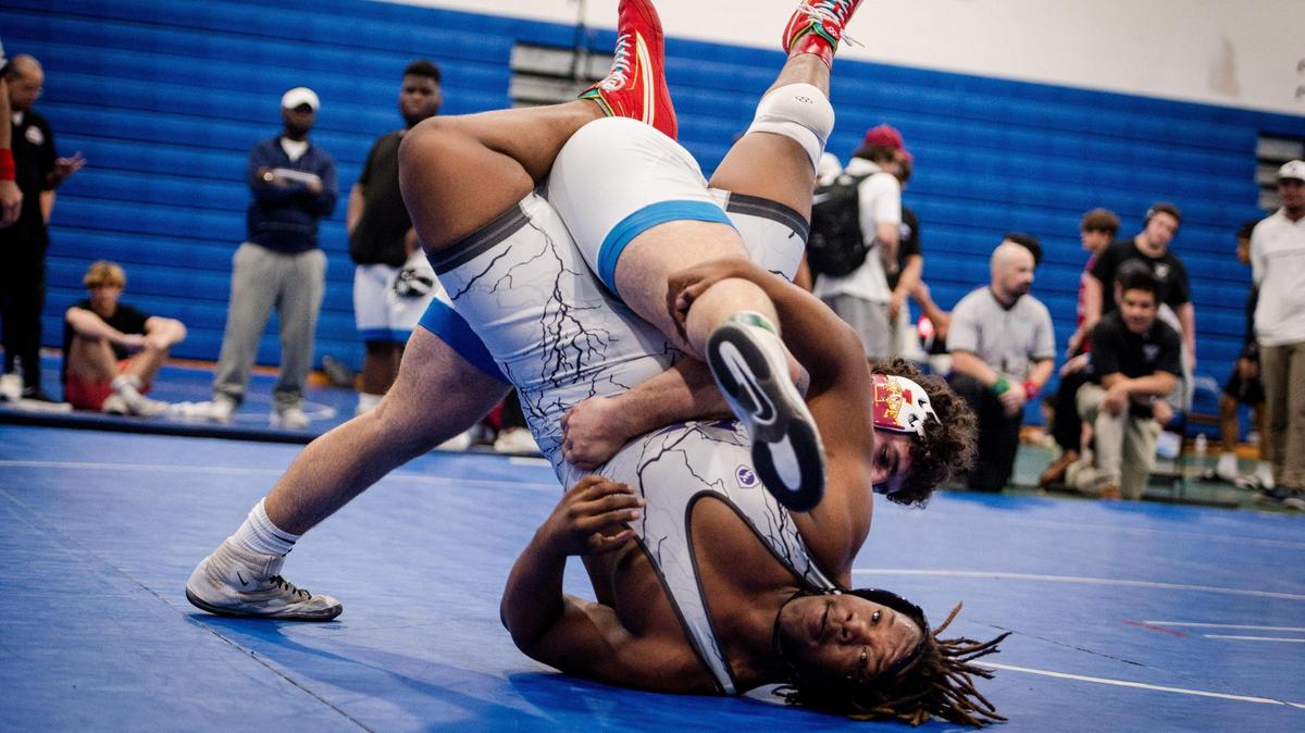 Homestead, February 3, 2024 - South Dade’s Sawyer Bartelt picks up Nathan Adras of Dr. Krop during the 2024 Boys GMAC Wrestling 175 weight class championship finals at South Dade Senior High School in Homestead, Florida, on Saturday, February 3, 2024.