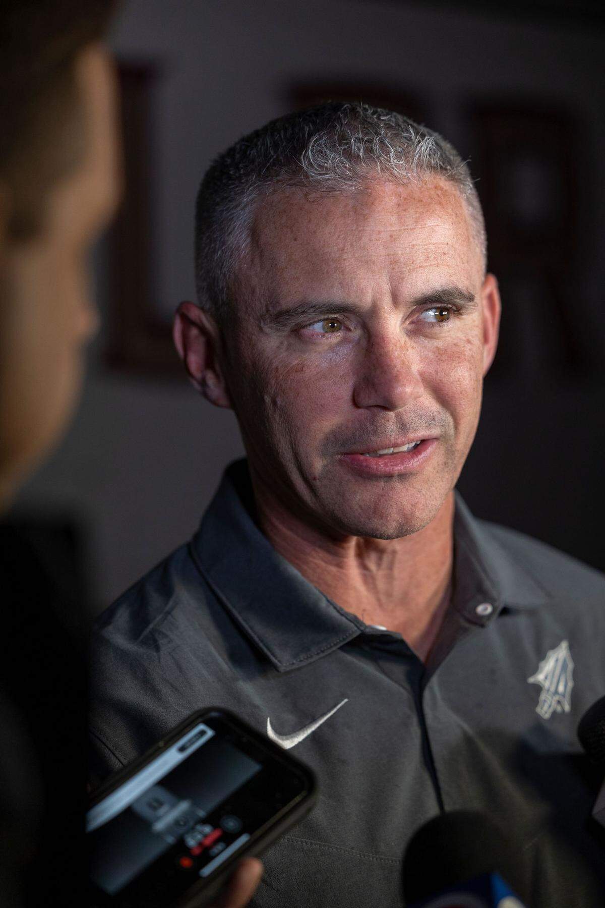 Florida State football coach Mike Norvell speaks to reporters on Monday night after the Seminoles arrived at Fort Lauderdale-Hollywood International Airport in advance of the Capital One Orange Bowl.