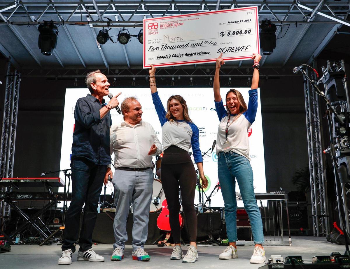 Burger Bash event manager Randy Fisher, at left, and South Beach Wine & Food Festival founder Lee Schrager, second from left, present Motek representatives the People’s Choice Award during the Burger Bash at the South Beach Wine & Food Festival.