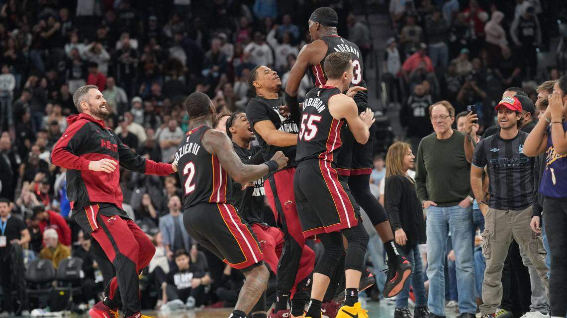 Miami Heat players celebrate after center Bam Adebayo (13) scored the winning basket at the end of the game to defeat the San Antonio Spurs at Frost Bank Center.