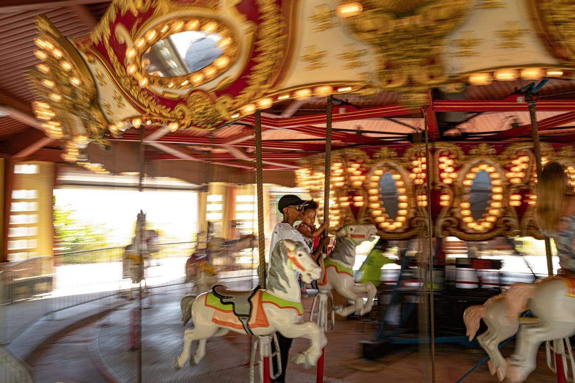 People ride the restored carousel at Historic Virginia Key Beach Park in Miami on Saturday, Nov. 12, 2022.