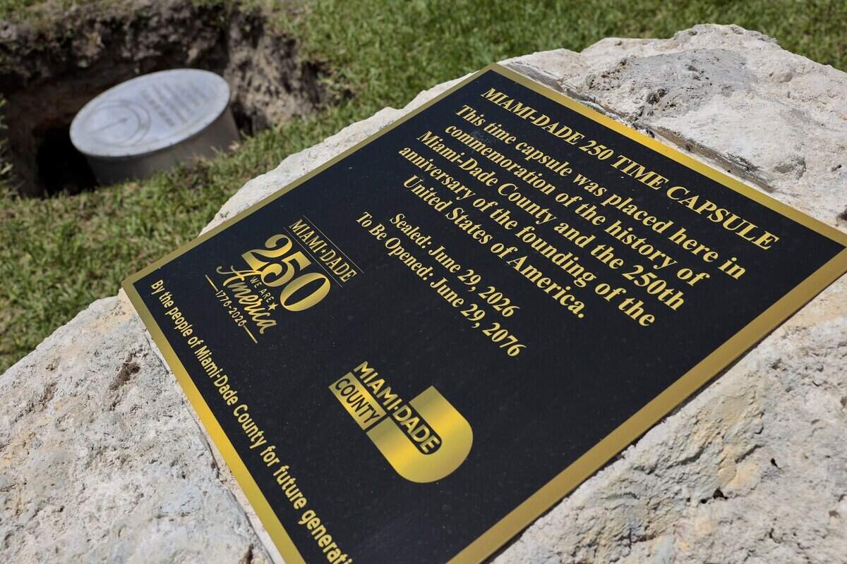 A capstone with a plaque commemorating the 250 time capsule sits next to the soon-to-be-buried 2026 time capsule on Monday, June 29, 2026, at Tropical Park in Miami-Dade County. Miami-Dade County marked America's 250th anniversary with a time capsule installation and America 250 Patriot Marker unveiling ceremony on Monday, June 29, 2026, at Tropical Park in Miami-Dade. The event celebrated the nation's history and aimed to preserve the present for future generations. The Miami-Dade 250 time capsule will remain sealed for 50 years, to be opened at the tricentennial in 2076, preserving the stories, achievements and cultural spirit of the community.