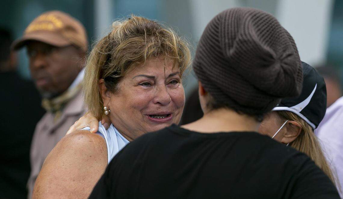 Yuby Cartes, left, waits for updates at the reunification center at 9301 Collins Ave in Surfside, Florida, on Thursday, June 24, 2021. A part of the Champlain Towers South Condo at 8777 Collins Ave. collapsed early Thursday.