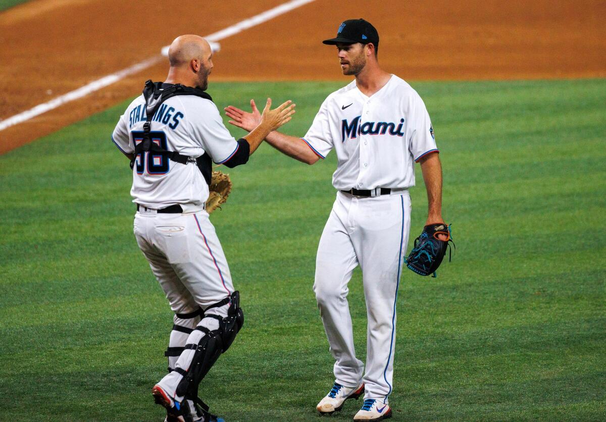 Miami Marlins pitcher Anthony Bender (55) and Marlins catcher Jacob Stallings (58) celebrates their 4-3 over the Philadelphia Phillies during the season home opener baseball game at LoanDepot Park on Thursday, April 14, 2022 in Miami, Florida.