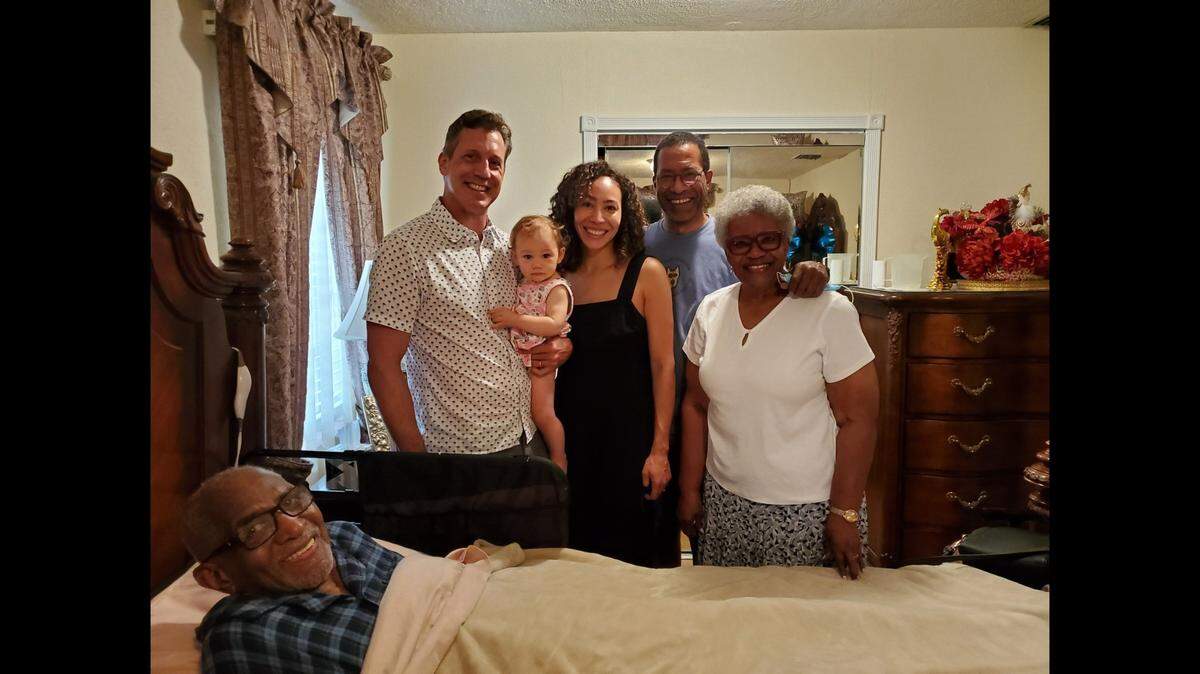 From left: Bradford Hardie holding daughter Loretta Jane (Lolo), Afra Hardie, Shawn Hines (maternal grandpa), and Bea L. Hines (maternal great-grandma). Bishop Walter H. Richardson is in bed.